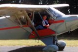 Jim in a red and gray airplane