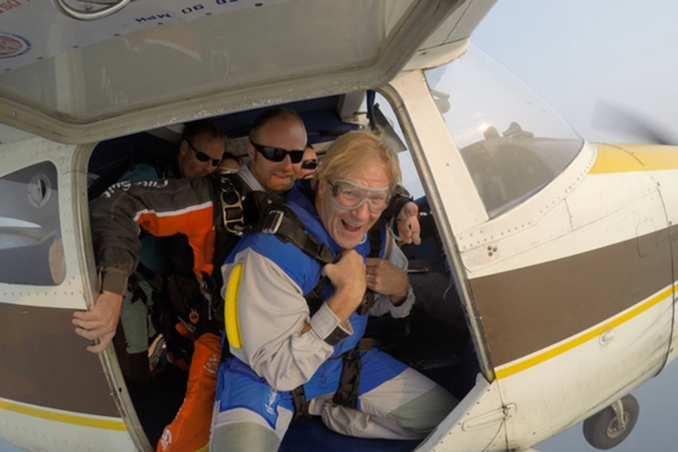 Male skydiving pair prepare to exit the Cessna