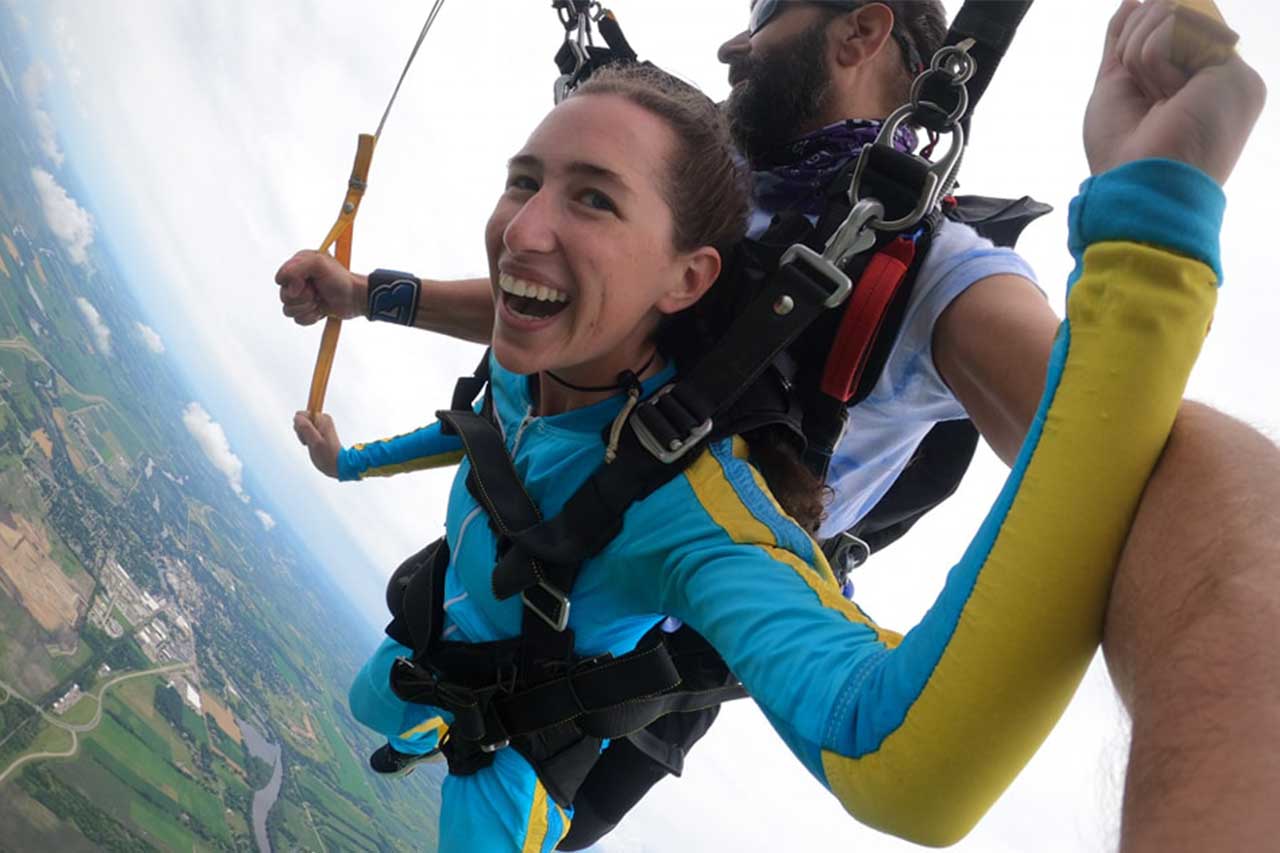 Woman under canopy on a tandem skydive