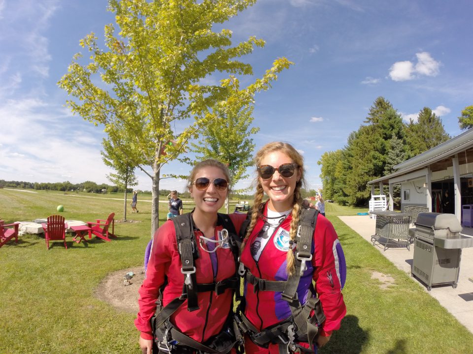 Two girls suited up in red jumpsuits preparing to skydive at Wisconsin Skydiving Center near Milwaukee, WI
