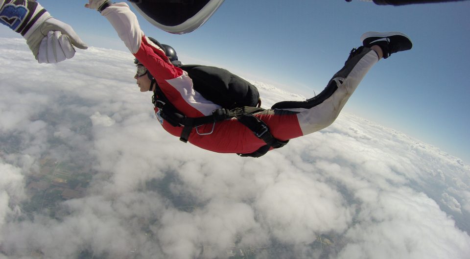 An AFF student demonstrates the perfect arch during an AFF jump to get her skydive license