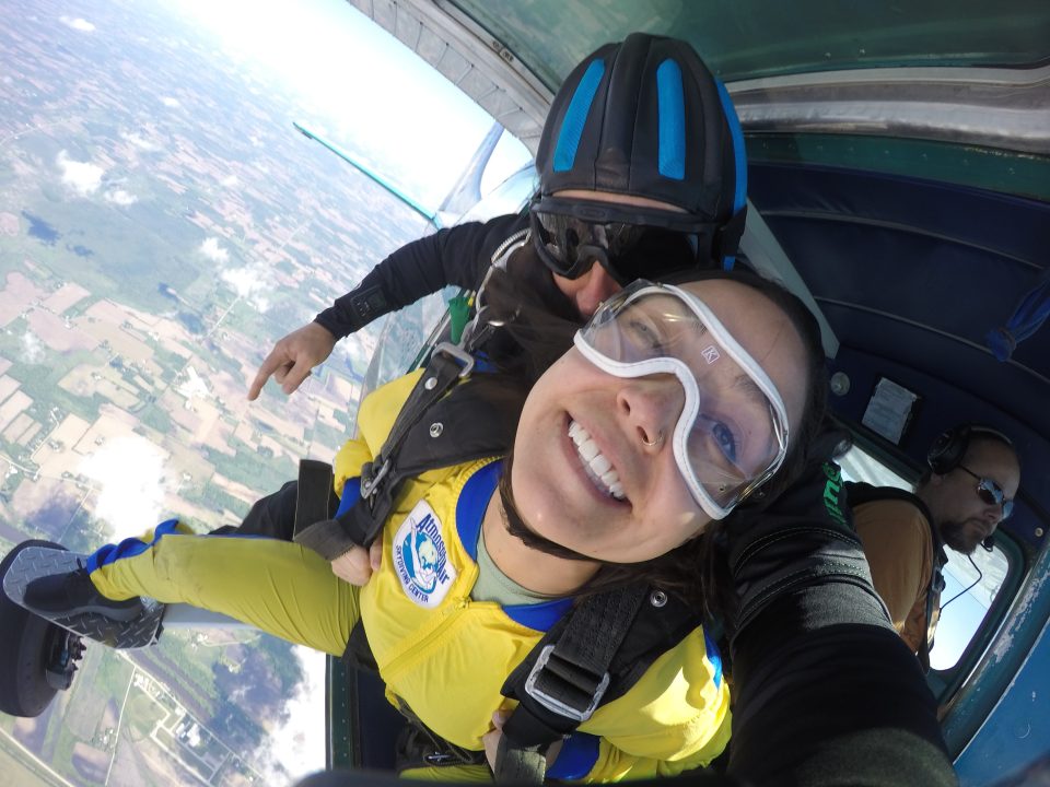 Girl smiling while coming out of a plane at Wisconsin Skydiving Center near Chicago