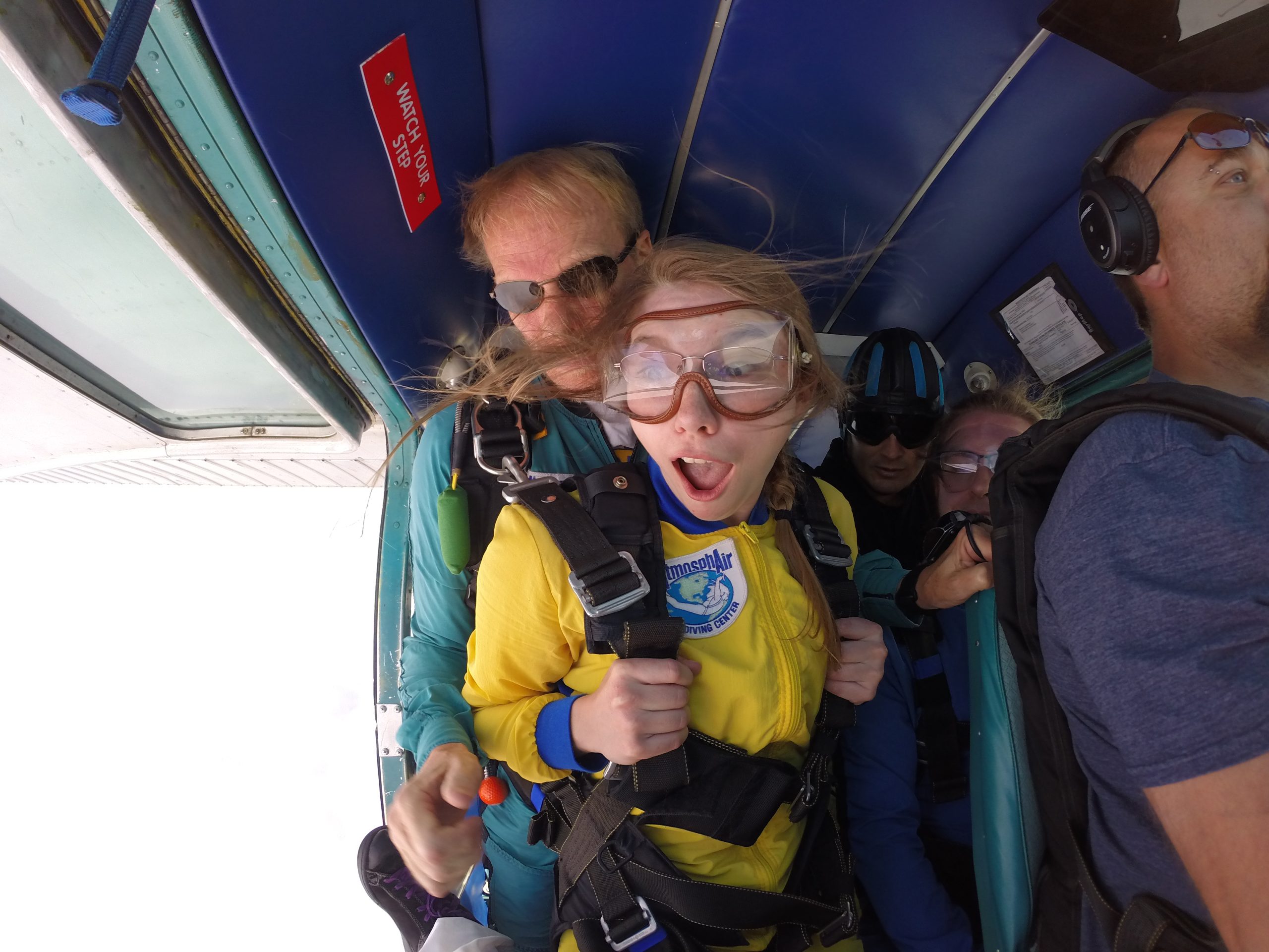 Tandem student and instructor at door of airplane right before exit into freefall