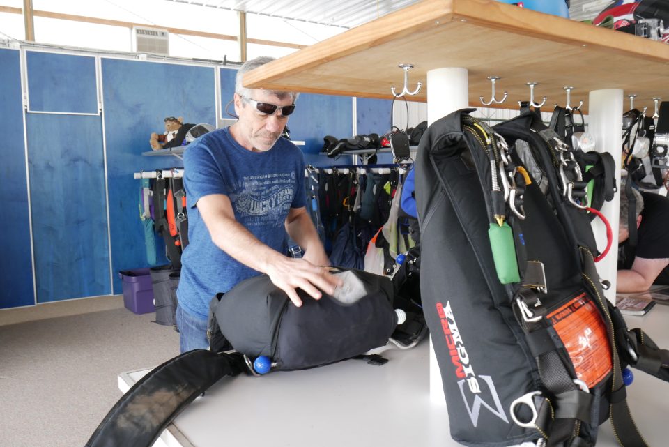 Bo Babovic packing a parachute at Wisconsin Skydiving Center near Madison, WI