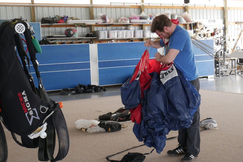 Skydiving instructor packing a parachute at the dropzone of Wisconsin Skydiving Center near Milwaukee, WI