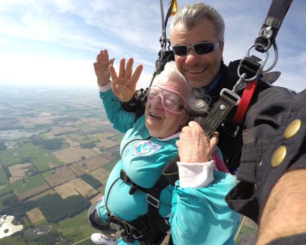 Bo Babovic smiles with tandem student Anna Mae at 4000' under canopy