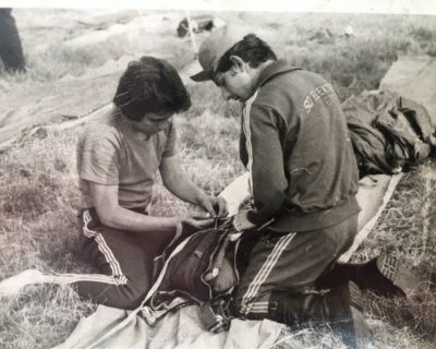 A black and white photo of Bo packing a parachute in 1975.