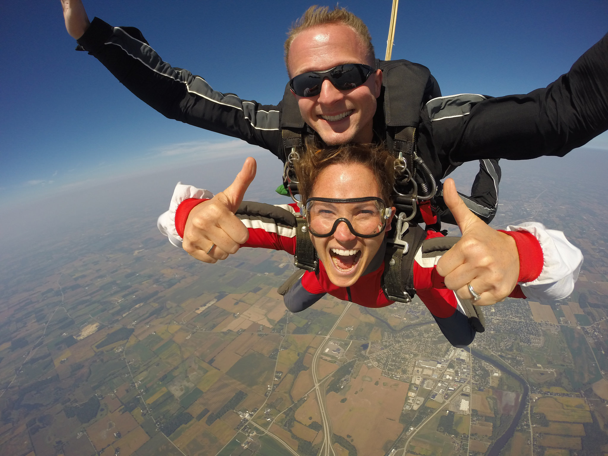 Girl giving two thumbs up while finishing a skydive at Wisconsin