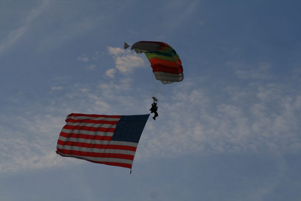 Alex Kolacio flying the US Flag under canopy on the 4th of July