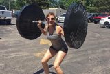 Skydiving instructor Laura Duffy lifting weights and exercising at Wisconsin Skydiving Center near Chicago