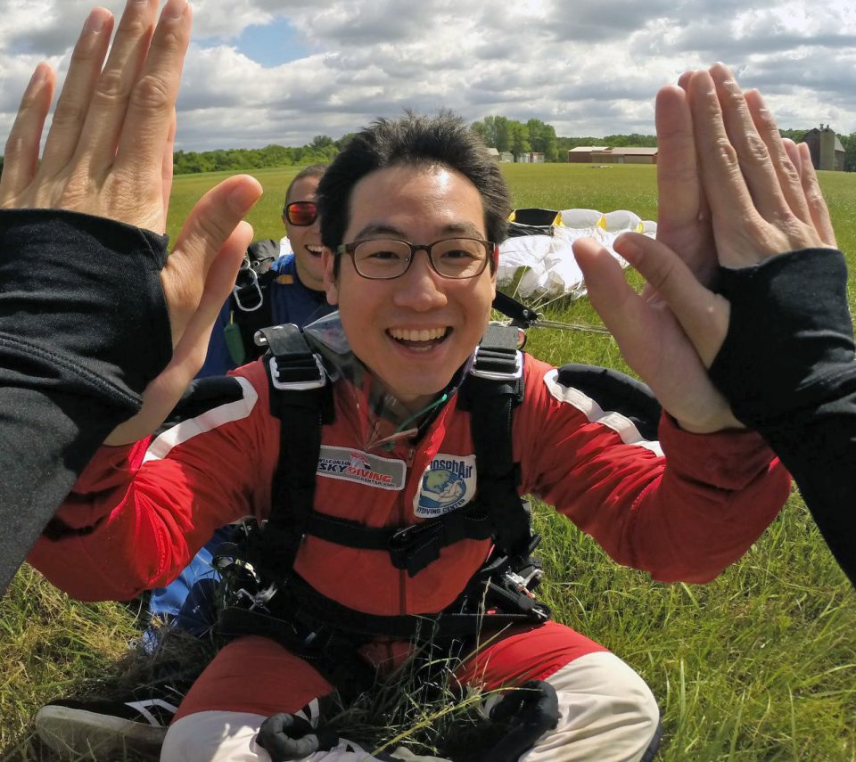 Skydiver high-fives another skydiver after his first tandem skydive at Wisconsin Skydiving Center near Milwaukee