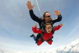 Skydiving instructor Joel Graves with happy tandem student
