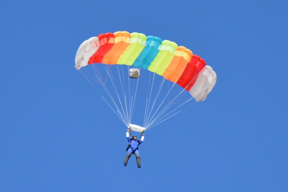 Skydiver shows how a parachute works.