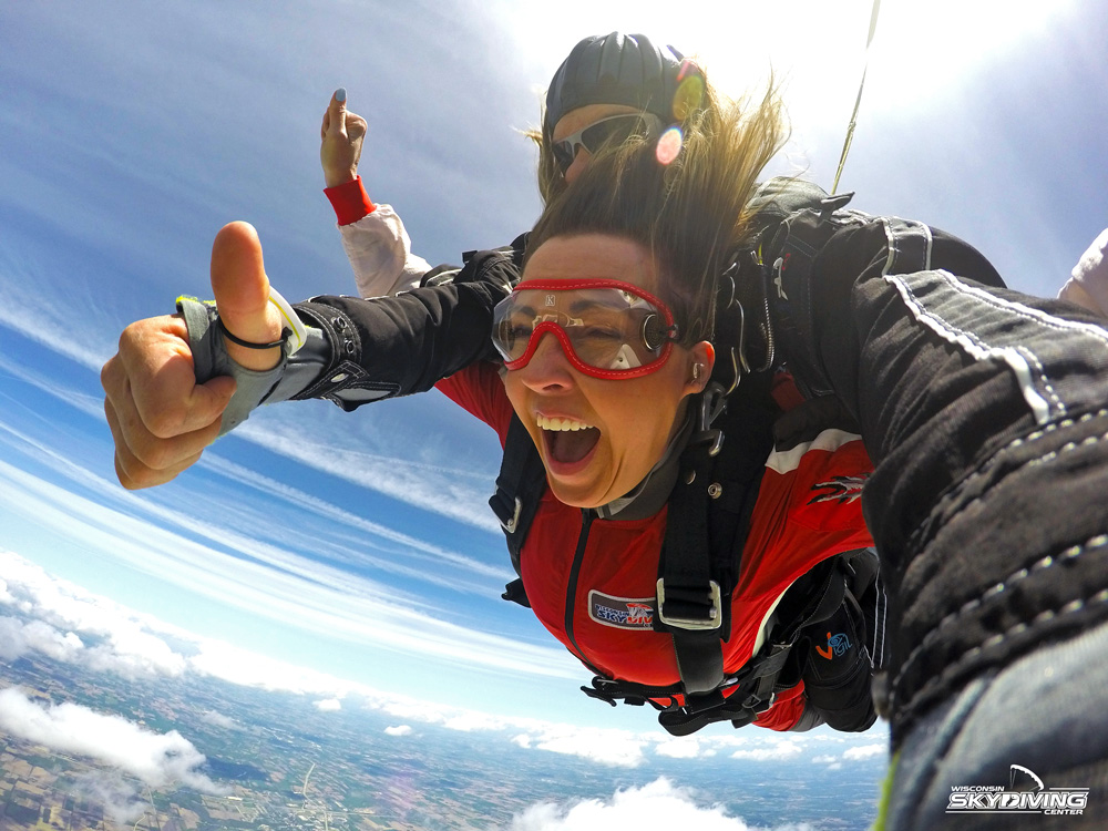 Woman wearing goggles & jumpsuit while skydiving at Wisconsin Skydiving Center near Milwaukee