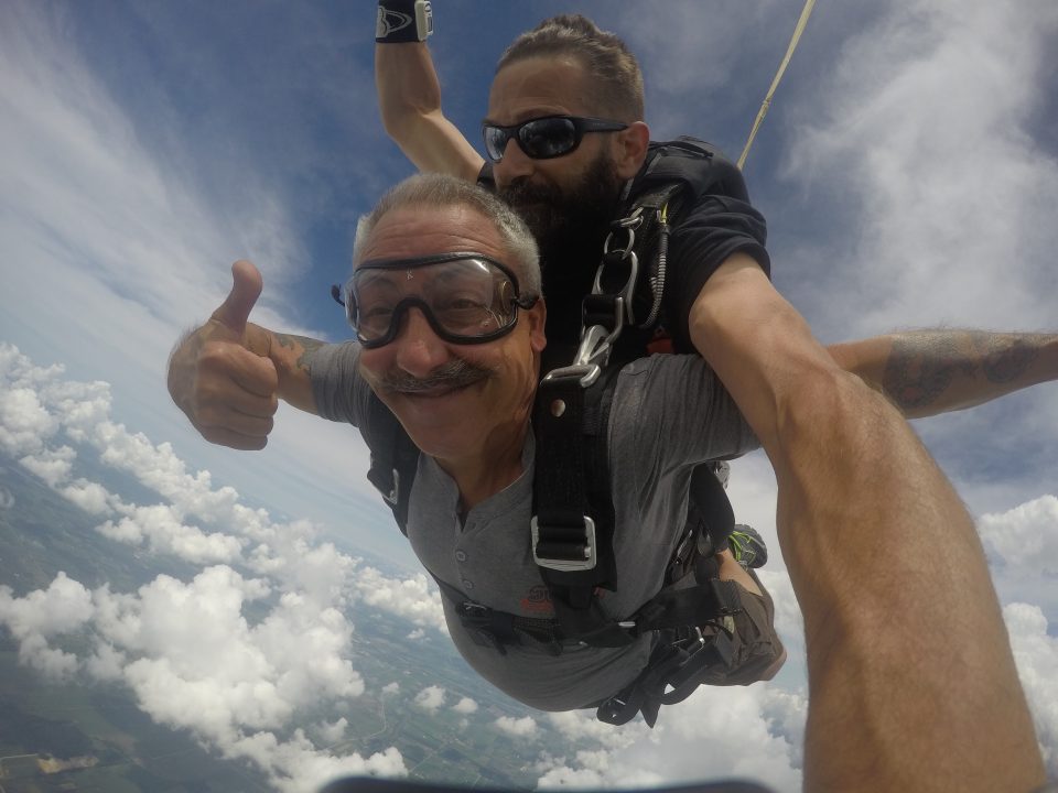 Man giving a thumbs up while skydiving at Wisconsin Skydiving Center near Chicago