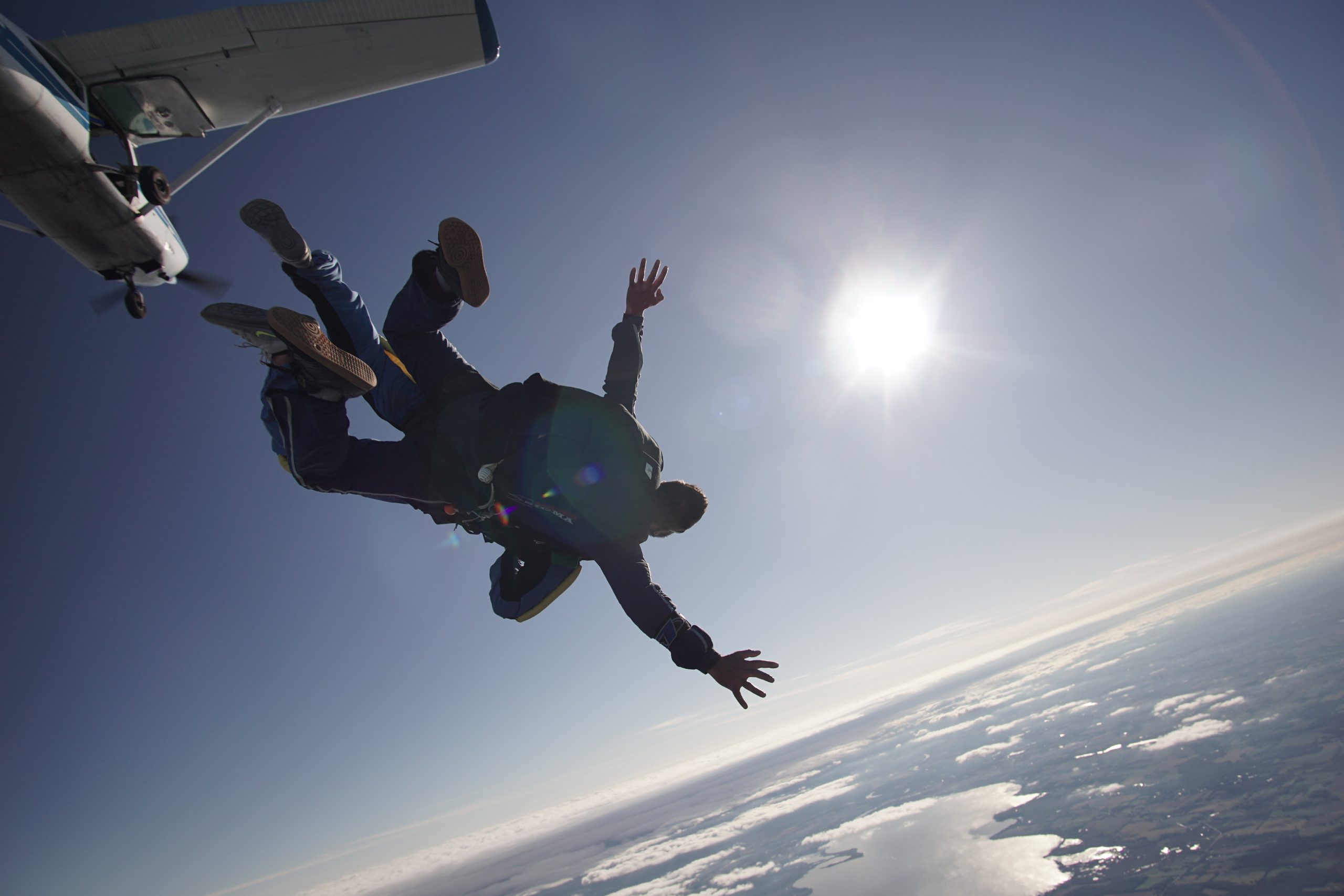 Silhouette of a tandem skydiver enjoying free fall at Wisconsin