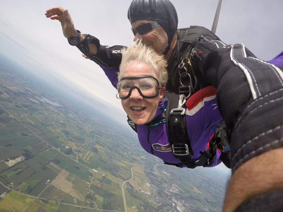 Woman smiling while tandem skydiving at Wisconsin Skydiving Center near Chicago