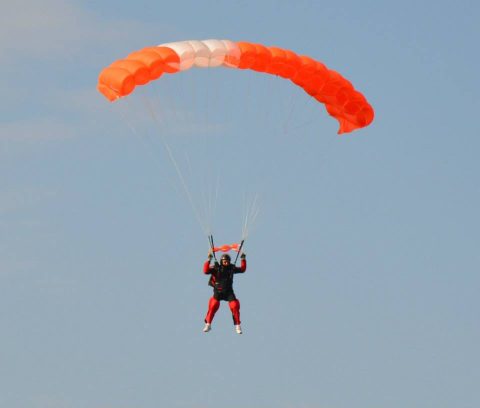 Mark flies his orange, skydiving parachute