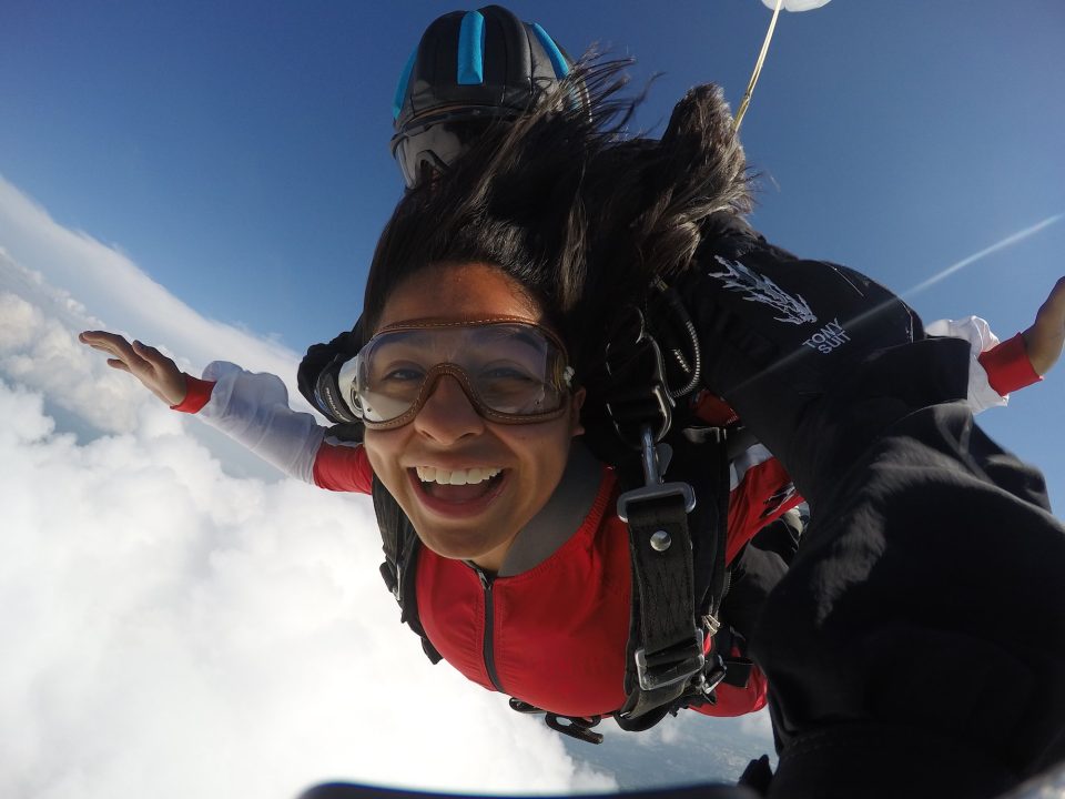 A girl smiles widely during free fall