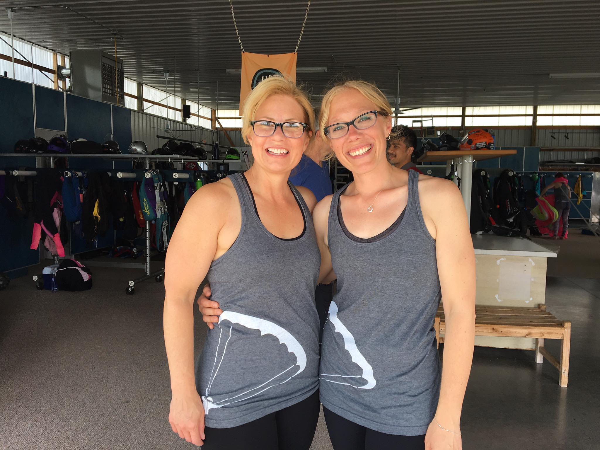 Christie Munn smiles for the camera with her friend in matching outfits.