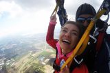Woman smiling while finishing her first skydive at Wisconsin Skydiving Center near Milwaukee