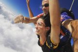 Woman with a big smile spreading her arms to fly at Wisconsin Skydiving Center near Milwaukee