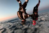 Two skydivers fly head down