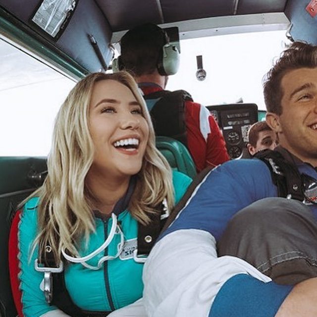 The cost of skydiving is worth it - Couple smiling in a plane as they prepare to jump out for AFF training at Wisconsin Skydiving Center near Chicago