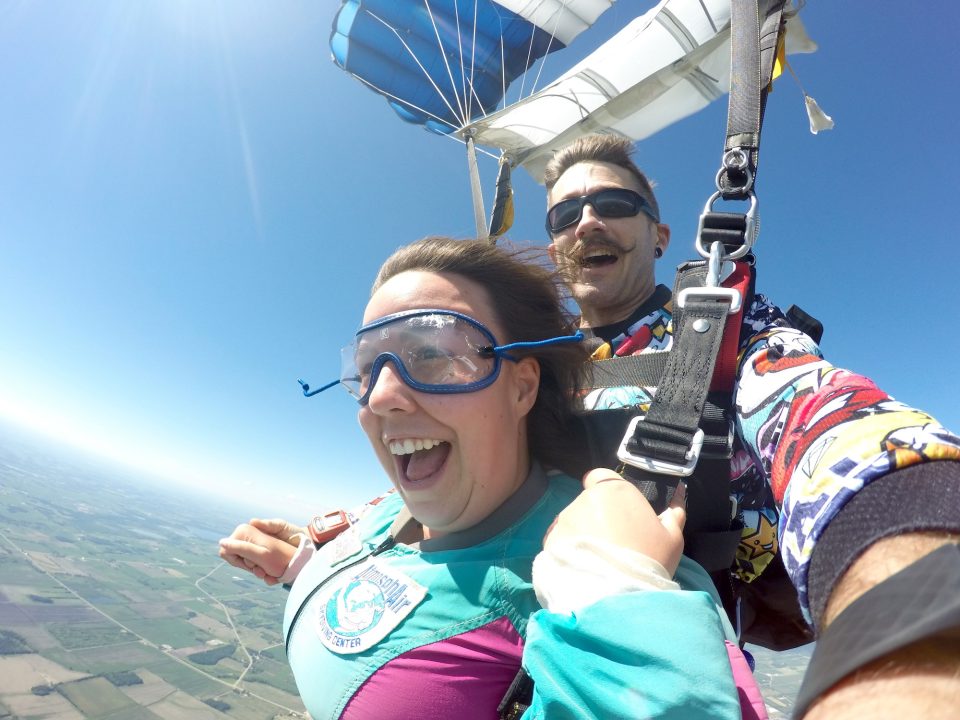 Girl smiling after a tandem skydive at Wisconsin Skydiving Center near Chicago