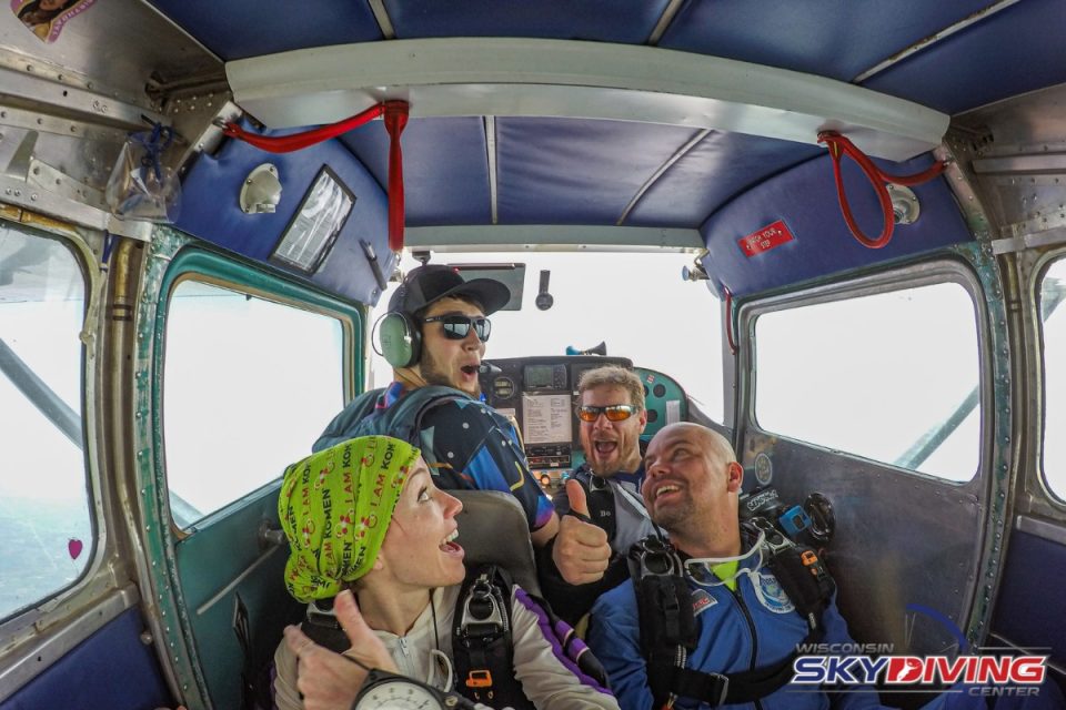 Tandem skydivers and instructors preparing to reach altitude at Wisconsin Skydiving Center near Chicago