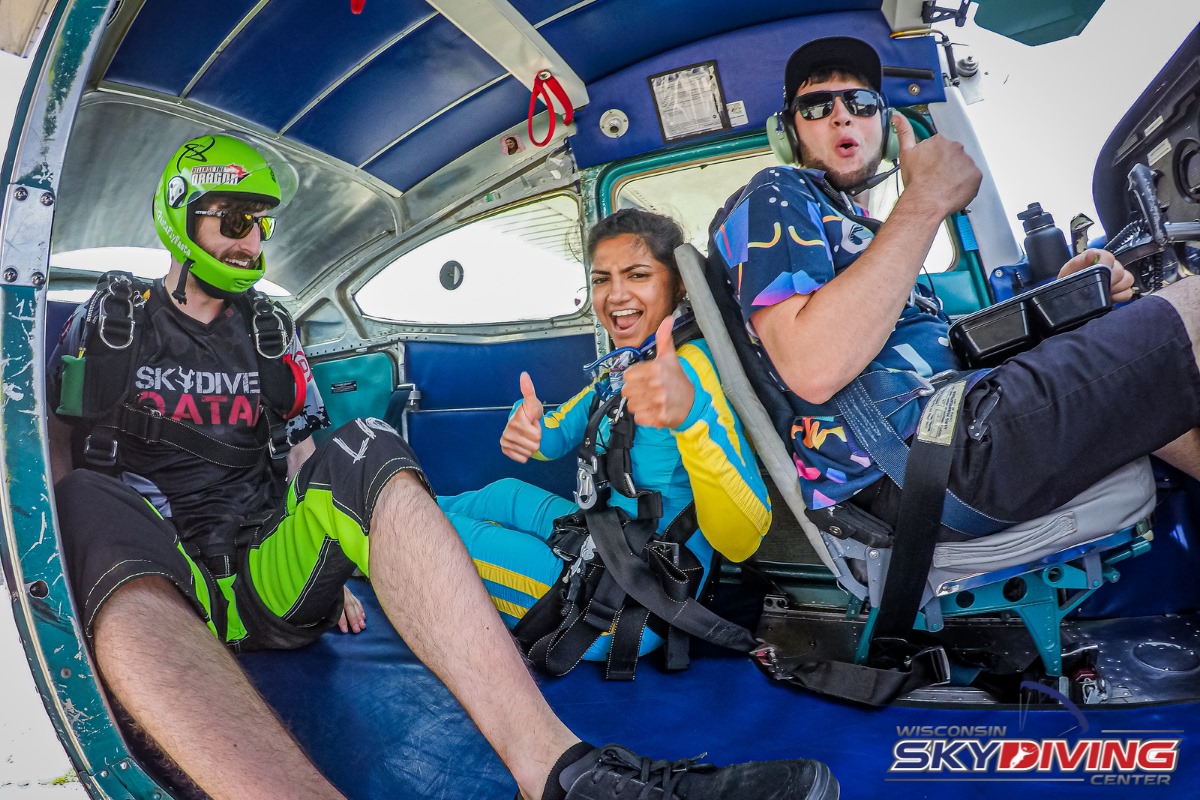 Woman giving thumbs up before jumping out of a plane at Wisconsin Skydiving Center near Chicago