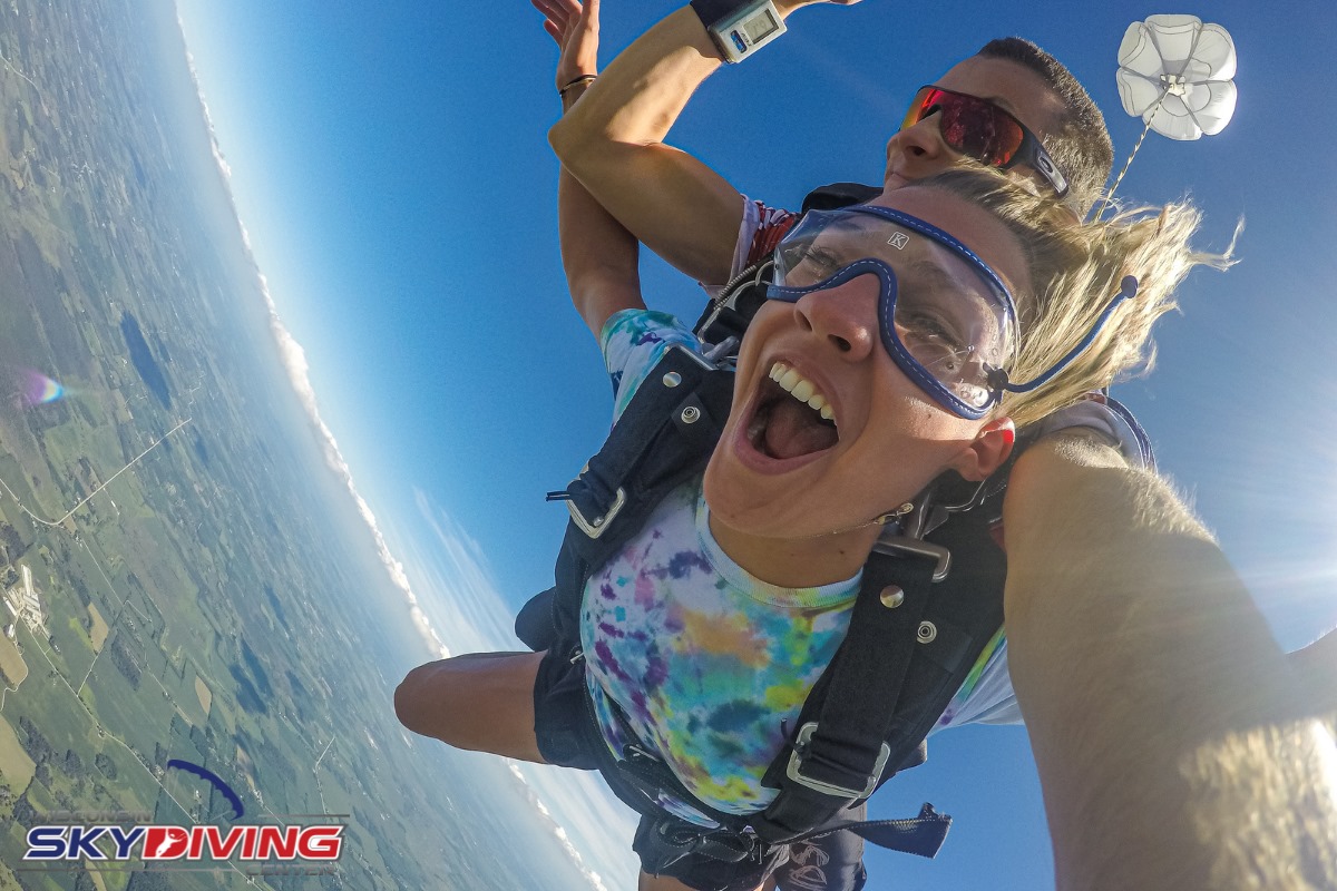Young woman wearing a tie dye shirt during freefall at Wisconsin Skydiving Center near Chicago