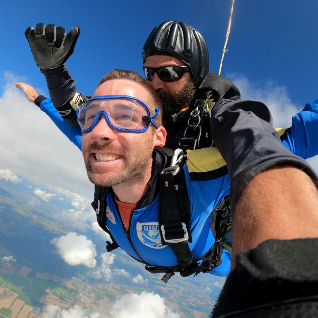 Man enjoying tandem freefall after his first skydive at Wisconsin Skydiving Center