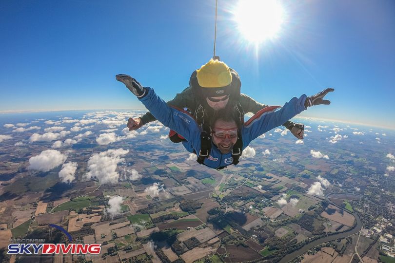 Man smiling with joy during tandem winter skydiving freefall at Wisconsin Skydiving Center near Chicago