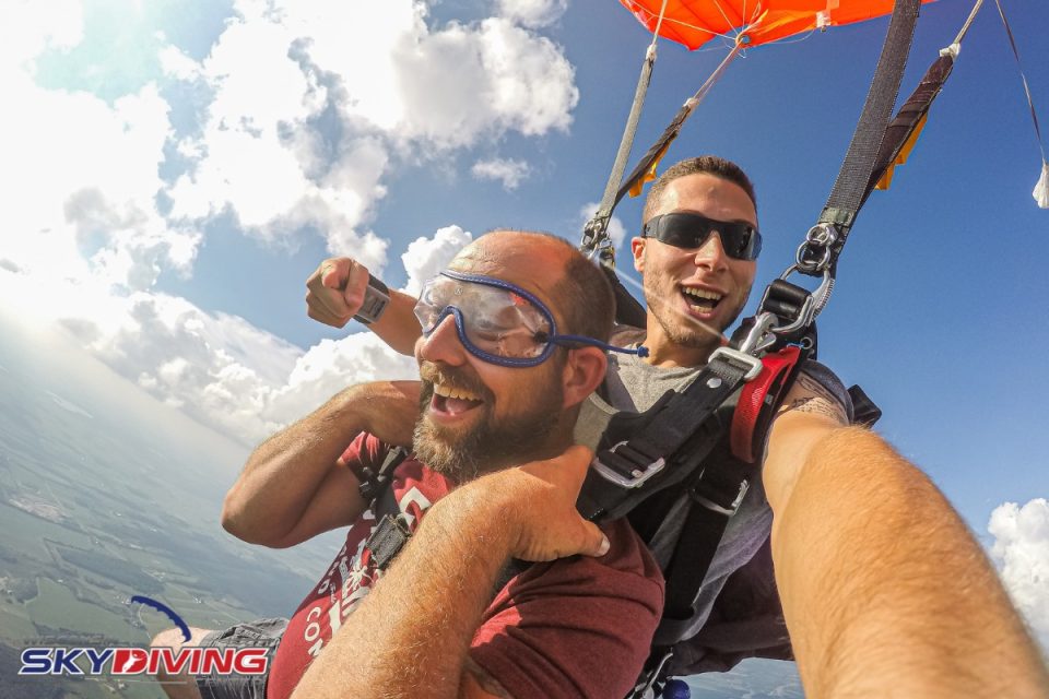 Man smiling with joy under canopy at Wisconsin Skydiving Center near Chicago