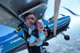 Woman jumping out of a plane for her first tandem skydive at Wisconsin Skydiving Center