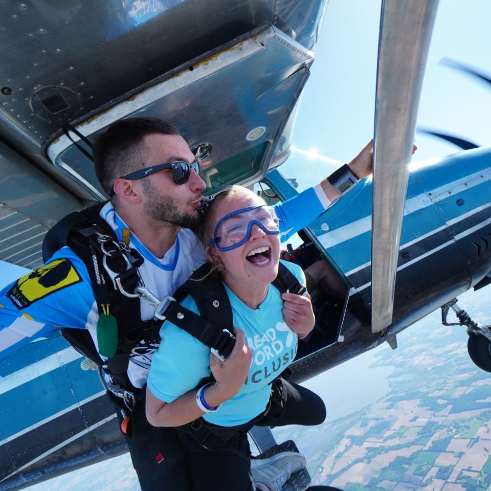 Woman jumping out of a plane for her first tandem skydive at Wisconsin Skydiving Center
