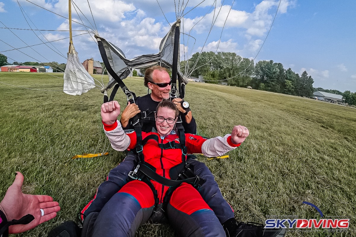 Woman smiling after landing her first tandem skydive at Wisconsin Skydiving Center near Chicago.