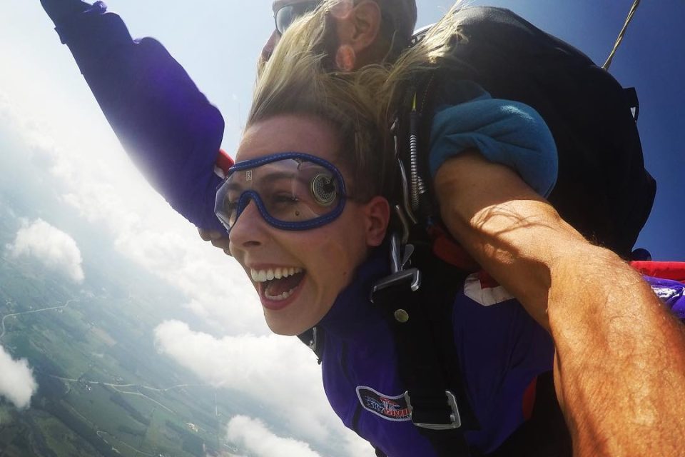 Woman smiling with joy during a tandem skydive at Wisconsin Skydiving Center near Madison