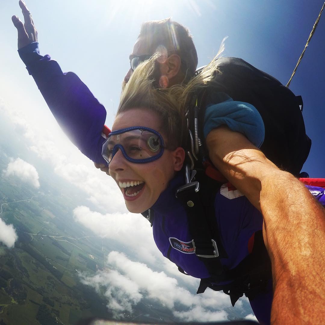Woman smiling with joy during a tandem skydive at Wisconsin Skydiving Center near Madison