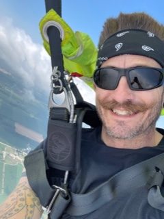 Instructor Andrew Leith smiling under parachute at Wisconsin Skydiving Center near Madison