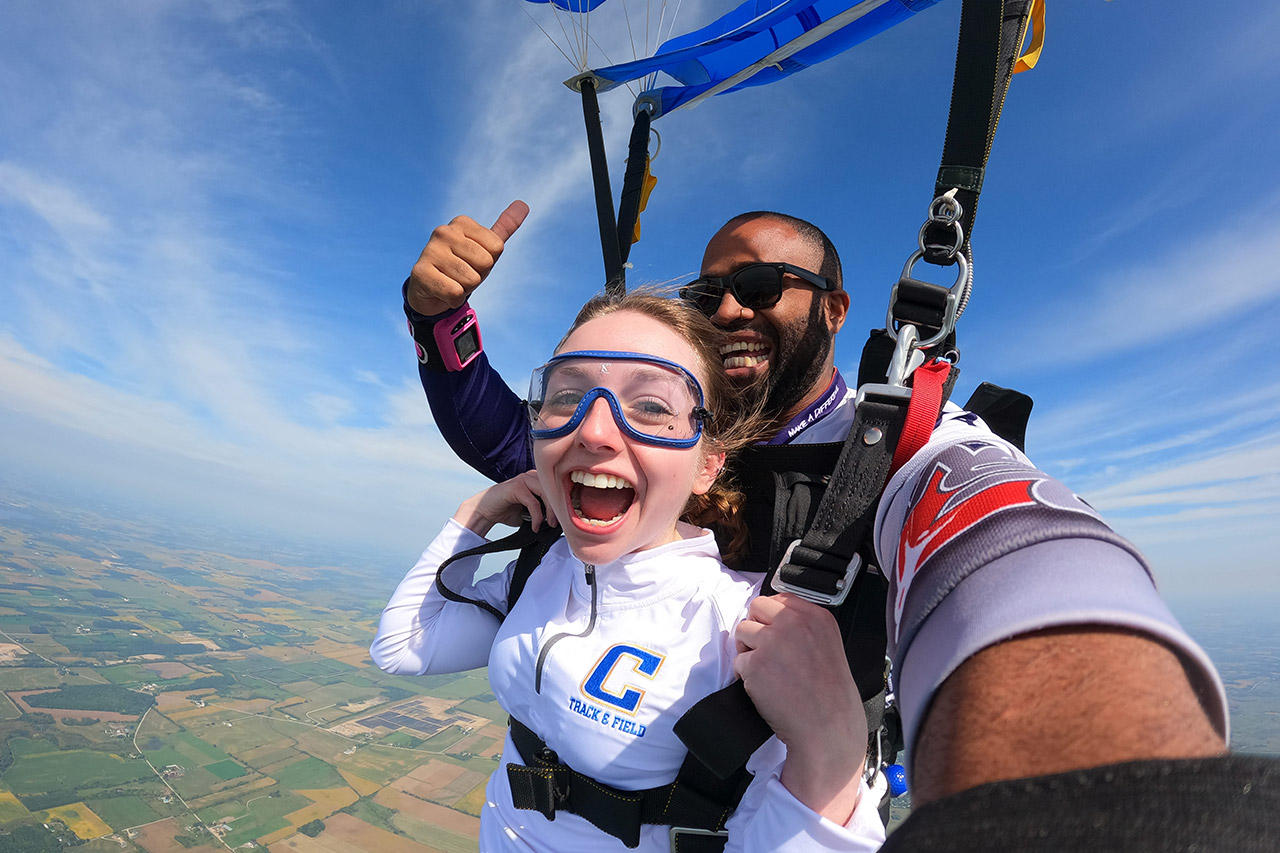 Female tandem student and her instructor smile under canopy