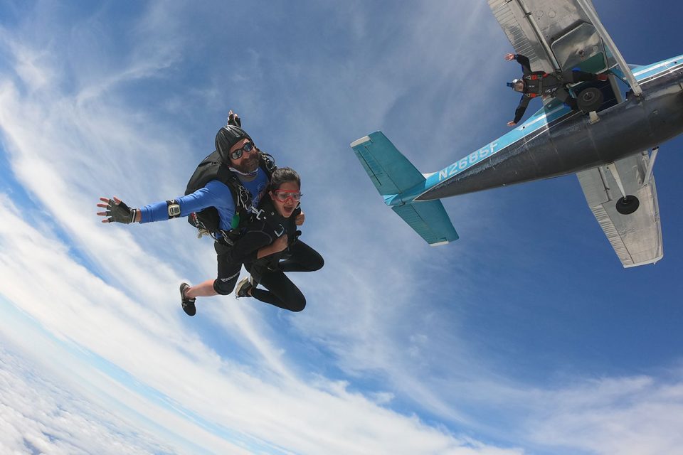 Tandem skydiving pair in freefall just after exiting the airplane