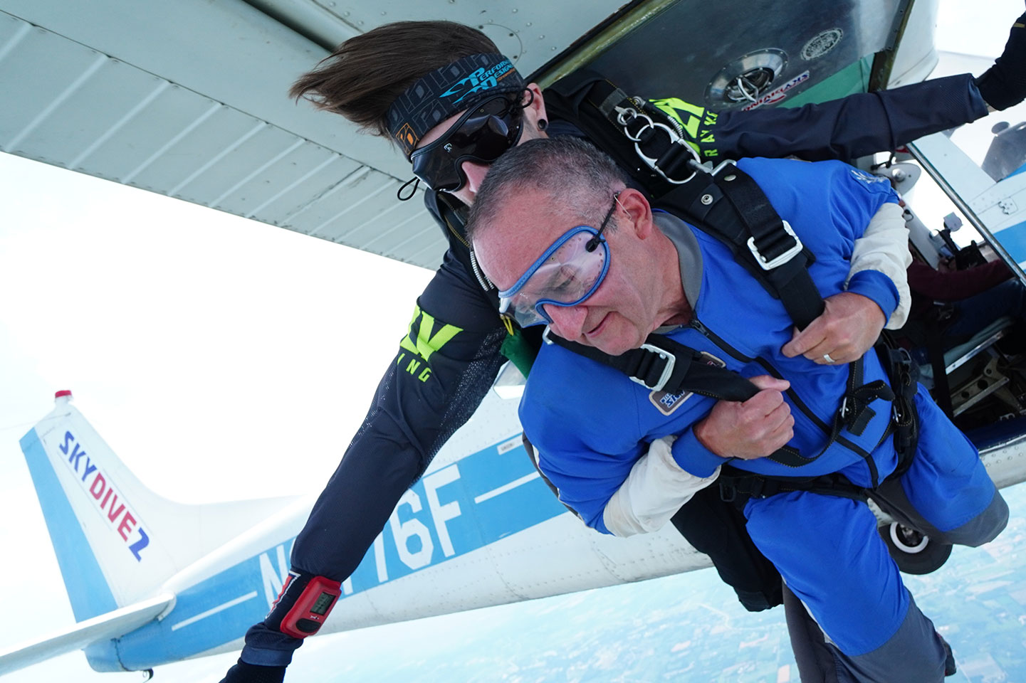 Tandem skydiving pair exit the airplane