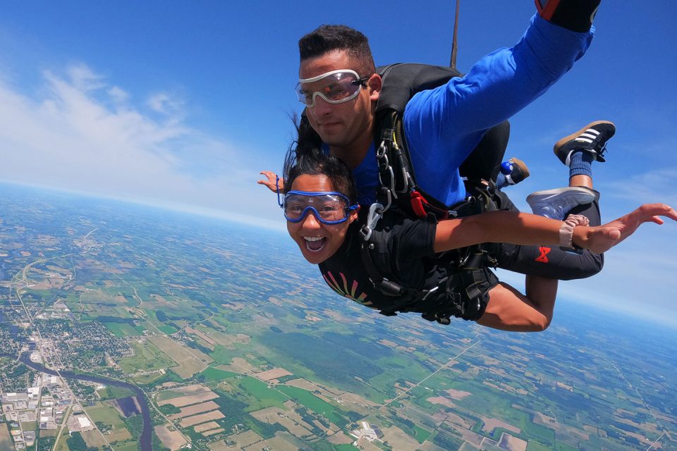 Skydiving female tandem student and her instructor over