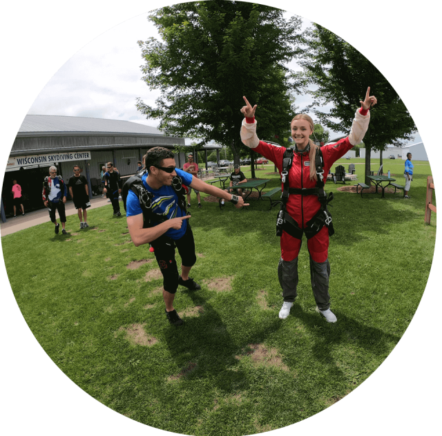 Female tandem student points to the sky while her instructor points at her