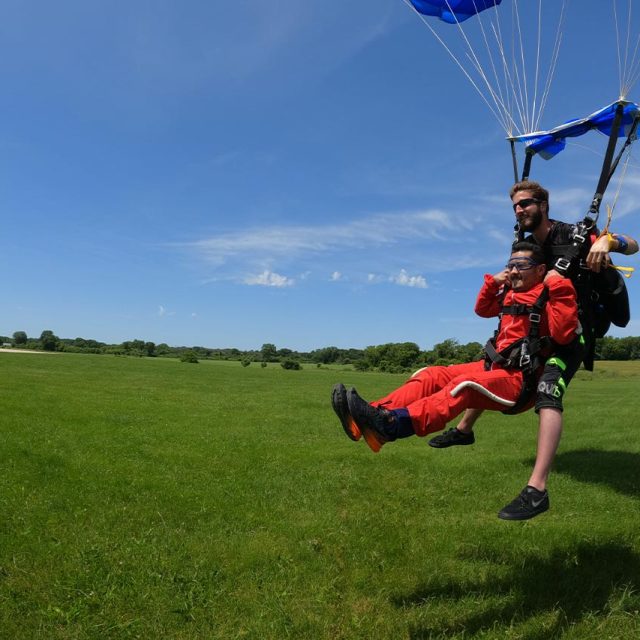 Male tandem pair landing from a skydive