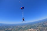 Tandem skydiving pair at the time of canopy deployment