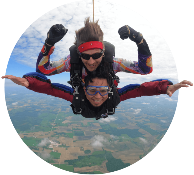 Male tandem skydiving pair in freefall