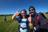 Woman giving a thumbs up after her first tandem skydive.
